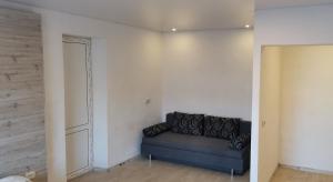a living room with a couch in the corner at Spas`ka Apartment in Peresadovka