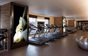 a gym with rows of treadmills and exercise equipment at InterContinental New York Times Square by IHG in New York