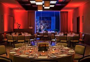 a room with long tables and chairs and red lighting at InterContinental New York Times Square by IHG in New York