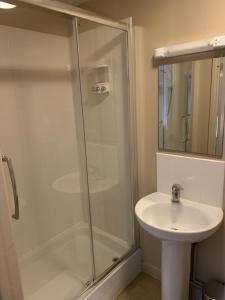 a bathroom with a shower and a sink at The Railway Inn in Malvern Wells