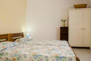 a bedroom with a bed and a white cabinet at Cycladic houses in rural surrounding 4 in Tholária