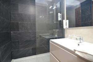 a bathroom with a sink and a shower at Hostería El Bodegón De Gredos in Arenas de San Pedro