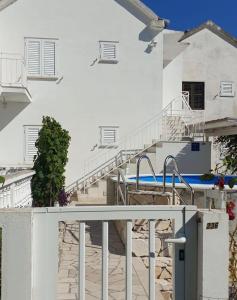 un edificio bianco con scala e piscina di La Bella Vita Viganj a Viganj