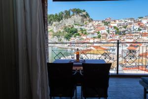 a table with a view of a city from a window at Petros Penthouse in Parga