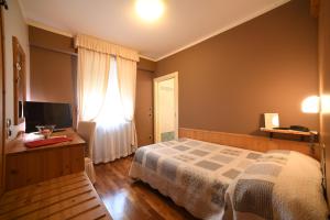 Postel nebo postele na pokoji v ubytování Hotel Lilla'