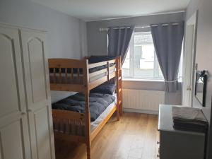 a room with two bunk beds and a window at West Coast Lodge in Lahinch