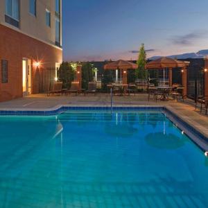 a large blue swimming pool in front of a building at Hyatt Place San Antonio Airport/Quarry Market in San Antonio