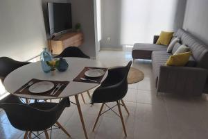 a living room with a table and chairs and a couch at Apartamento Yellow Garrucha in Garrucha