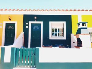 a colorful house with two doors and a window at Camping Villa Park Zambujeira do Mar in Zambujeira do Mar