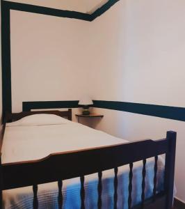 a bedroom with a bed with a black head board at Camping Villa Park Zambujeira do Mar in Zambujeira do Mar