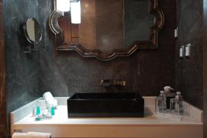 a bathroom with a sink and a mirror at 1850 Hotel Boutique in Guanajuato