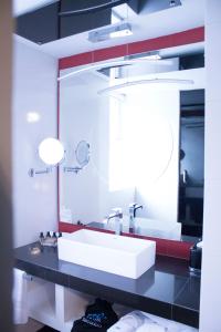 a bathroom with a sink and a mirror at 1850 Hotel Boutique in Guanajuato