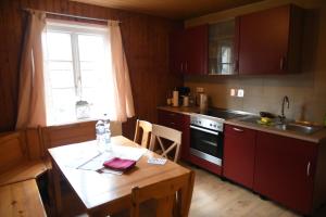 a kitchen with a wooden table and a small table and a tableablish at Ferienwohnung am Dorm in Süpplingenburg +18 photos