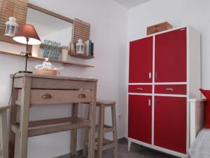 een slaapkamer met een rode dressoir en een rode kast bij Ático Baños del Carmen in Cádiz