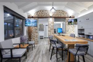 una cucina e una sala da pranzo con tavolo e sedie di Villa Elia Resort a Città di Lefkada