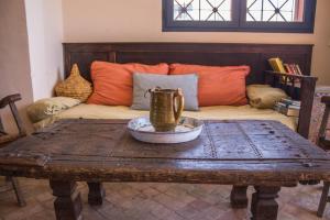 a living room with a table and a couch at Imsouane Surf Paradise in Imsouane