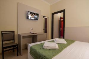 Voodi või voodid majutusasutuse Hotel Dei Fiori toas