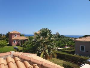 a view from the roof of a house with a palm tree at Monambeles Villas in Svoronata