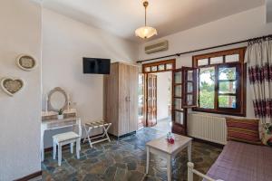 a living room with a couch and a table at Samaria Studios in Hora Sfakion