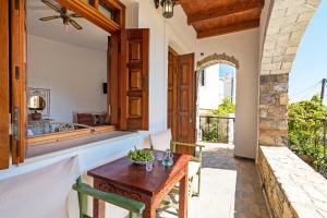 a dining room with a table and a balcony at Samaria Studios in Hora Sfakion