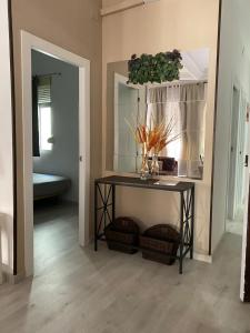 a room with a table with a mirror and a sink at Apartamentos Turia in Valencia