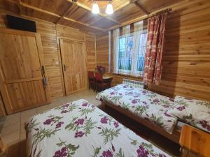 a bedroom with two beds and a window at Domek Majowy ze strefą Wellness in Susiec +51 photos