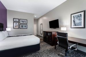 a hotel room with a large bed and a television at La Quinta by Wyndham Huntsville Airport Madison in Madison