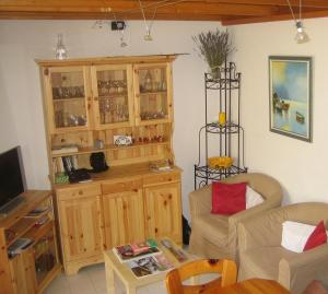 a living room with a couch and a cabinet at Vias Plage - Maison de vacances in Vias
