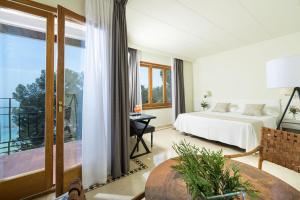 a bedroom with a bed and a balcony at Hotel Santa Marta in Lloret de Mar