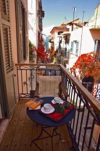 a blue table on a balcony with a breakfast at Andromeda Suites in Nafplio