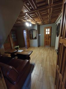 a living room with a couch and a table at Pokoje Gościnne Majka in Mrągowo