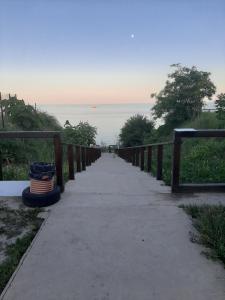 a walkway leading down to a beach with the ocean at Mini Hotel Уютный дворик in Odesa