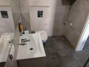 a bathroom with a sink and a toilet at Apartamenty Słoneczna 42 in Gdynia +29 photos