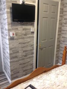 ein Schlafzimmer mit einem Spiegel und einem TV an der Wand in der Unterkunft Sherwood Lodge in Skegness