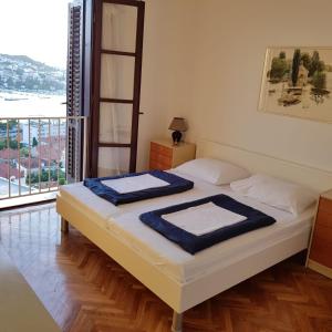 a bedroom with a bed with a view of the ocean at Apartment Anet with free parking in Dubrovnik