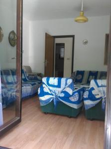 a room with two beds and a mirror at Apartmani Vrzić in Baška