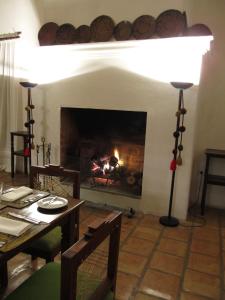 a living room with a fireplace and a fire place at La Merced Del Alto in Cachí