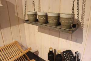a shelf with four coffee cups on it at Berggatan Villa - lägenhet 2 in Funäsdalen