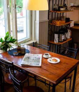 a wooden table with a plate of food on it at Park Hotell in Örnsköldsvik