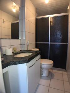 a bathroom with a sink and a toilet in it at Apartamento Mobiliado Vila Iracema in Fortaleza