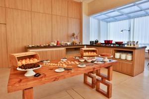 a kitchen with a table with food on it at Hotel Fernandópolis in Fernandópolis