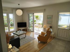 a living room with a couch and a table at Two Palm Trees Apartment in Nydri