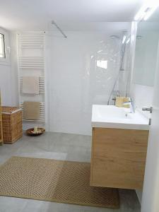a white bathroom with a sink and a shower at Two Palm Trees Apartment in Nydri +13 photos