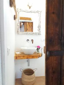 a bathroom with a sink and a mirror at Deppy Cottage in Porto Columbu - Perdʼe Sali