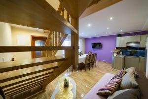 a living room with a couch and a kitchen at Cichy Zakątek - Sauna Jacuzzi SPA RELAX SOLINA BIESZCZADY in Lesko