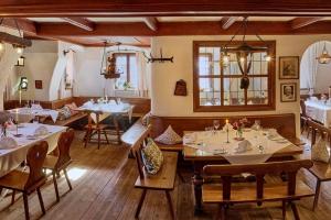 a restaurant with tables and chairs in a room at Romantik Hotel Zum Klosterbräu in Neuburg an der Donau