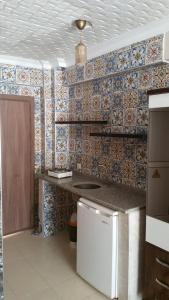 a kitchen with a counter and a tile wall at Haciely Thermal Otel in Denizli