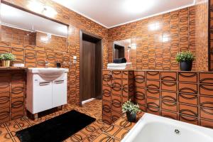 a bathroom with a sink and a mirror and a tub at Dolce Vita in Gdańsk +38 photos