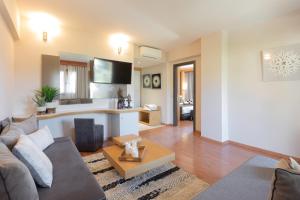a living room with a couch and a table at La Piscine Art Hotel, Philian Hotels and Resorts in Skiathos