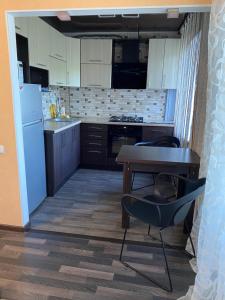 a kitchen with a table and a table and a chair at Apartment in the center in Zhytomyr